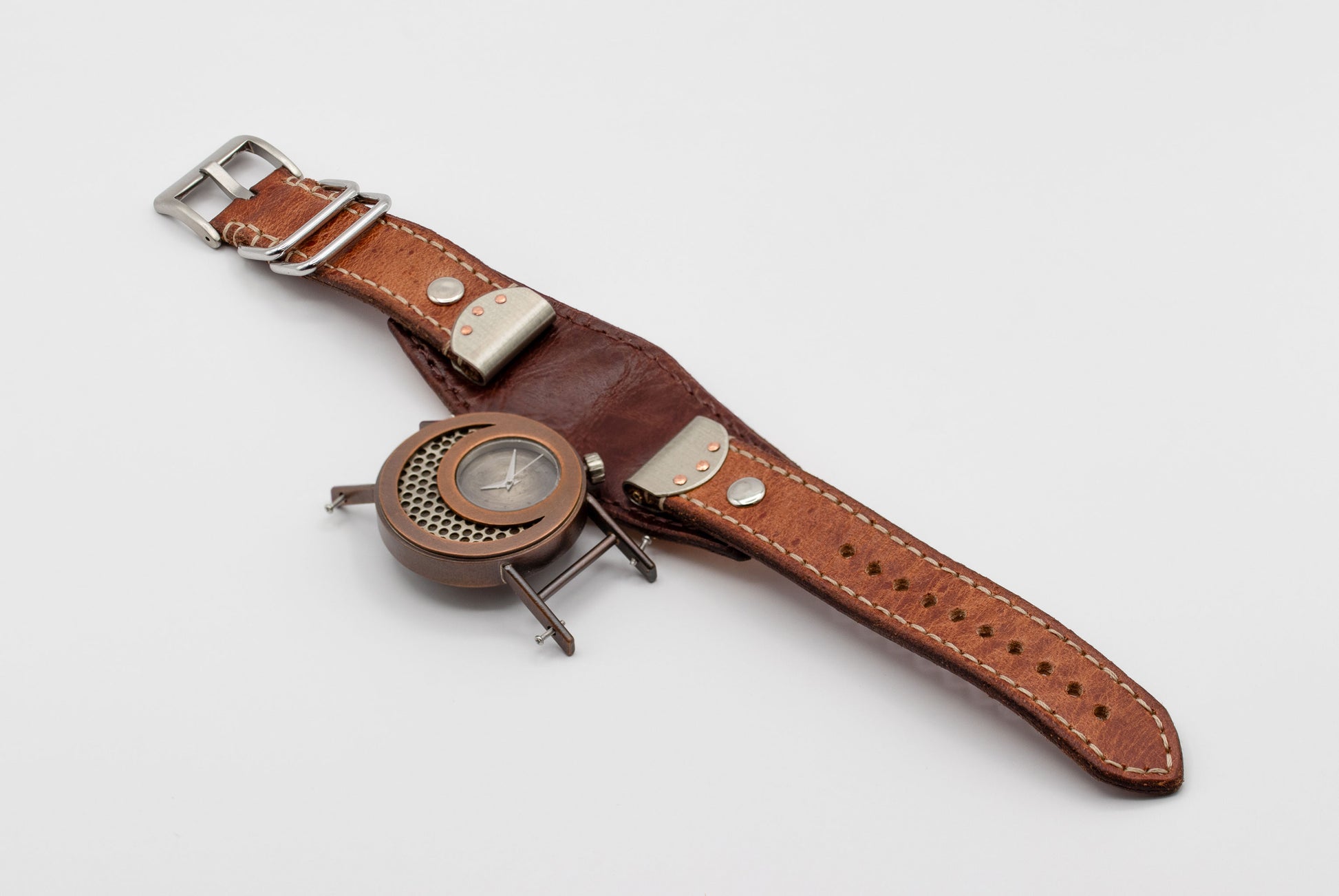 Watch with a brown leather strap on a light gray background