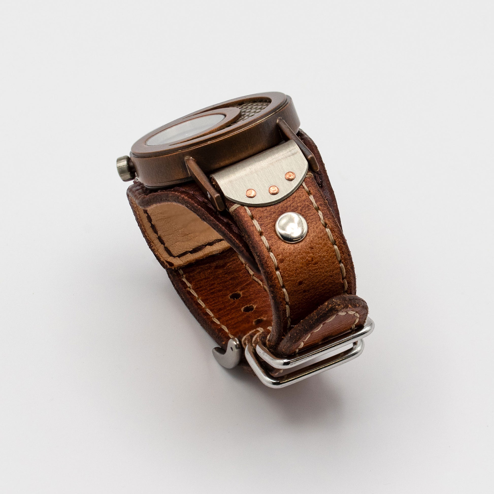 Brown leather watch with metal clasp on a white background