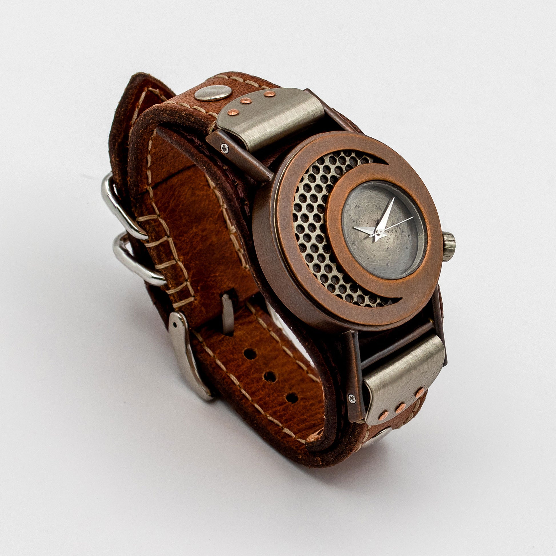Steampunk-style wristwatch with brown leather strap and metallic copper casing on a white background