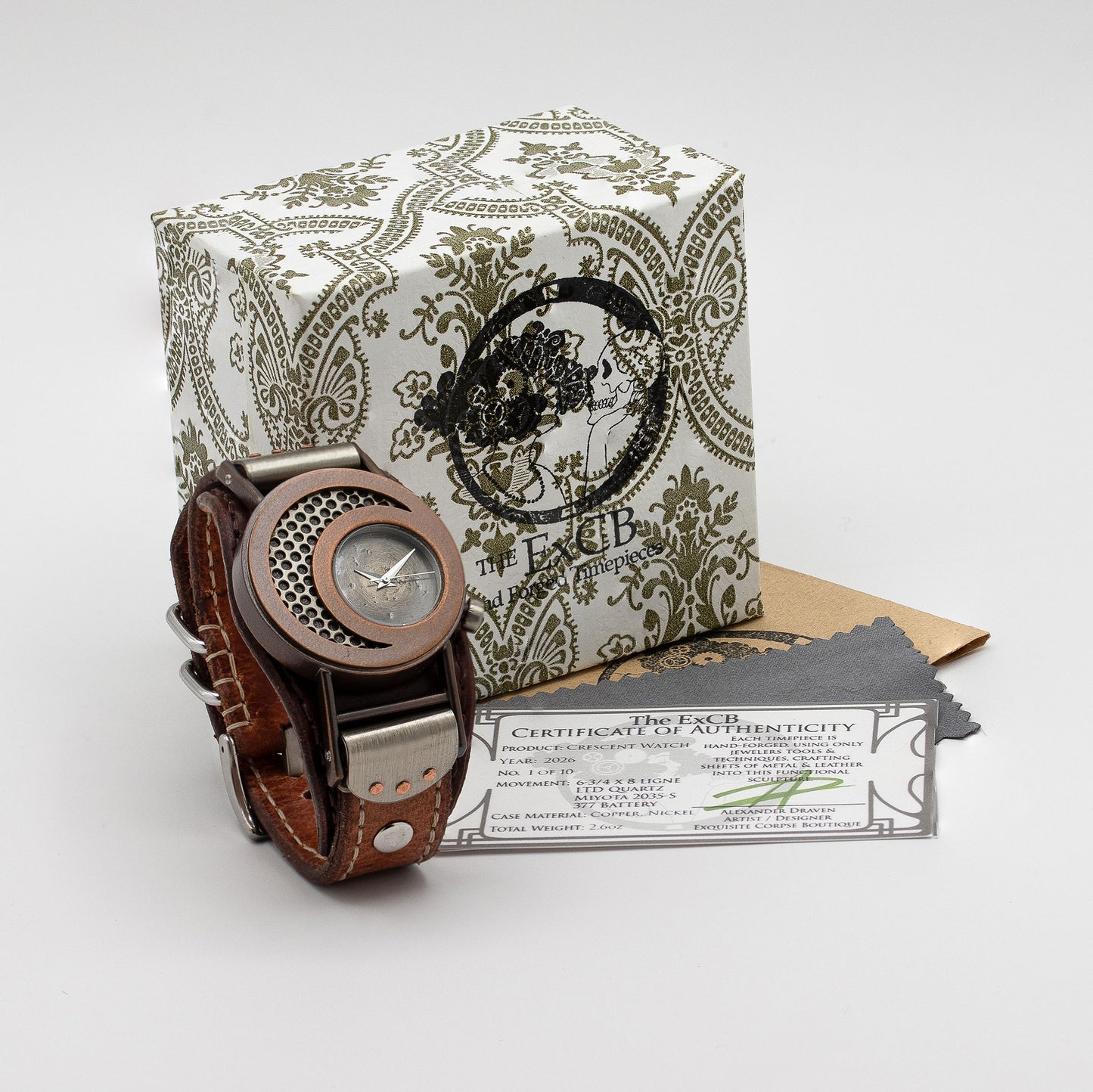 Steampunk wristwatch with brown leather strap on a patterned box with 'ExCB' branding.