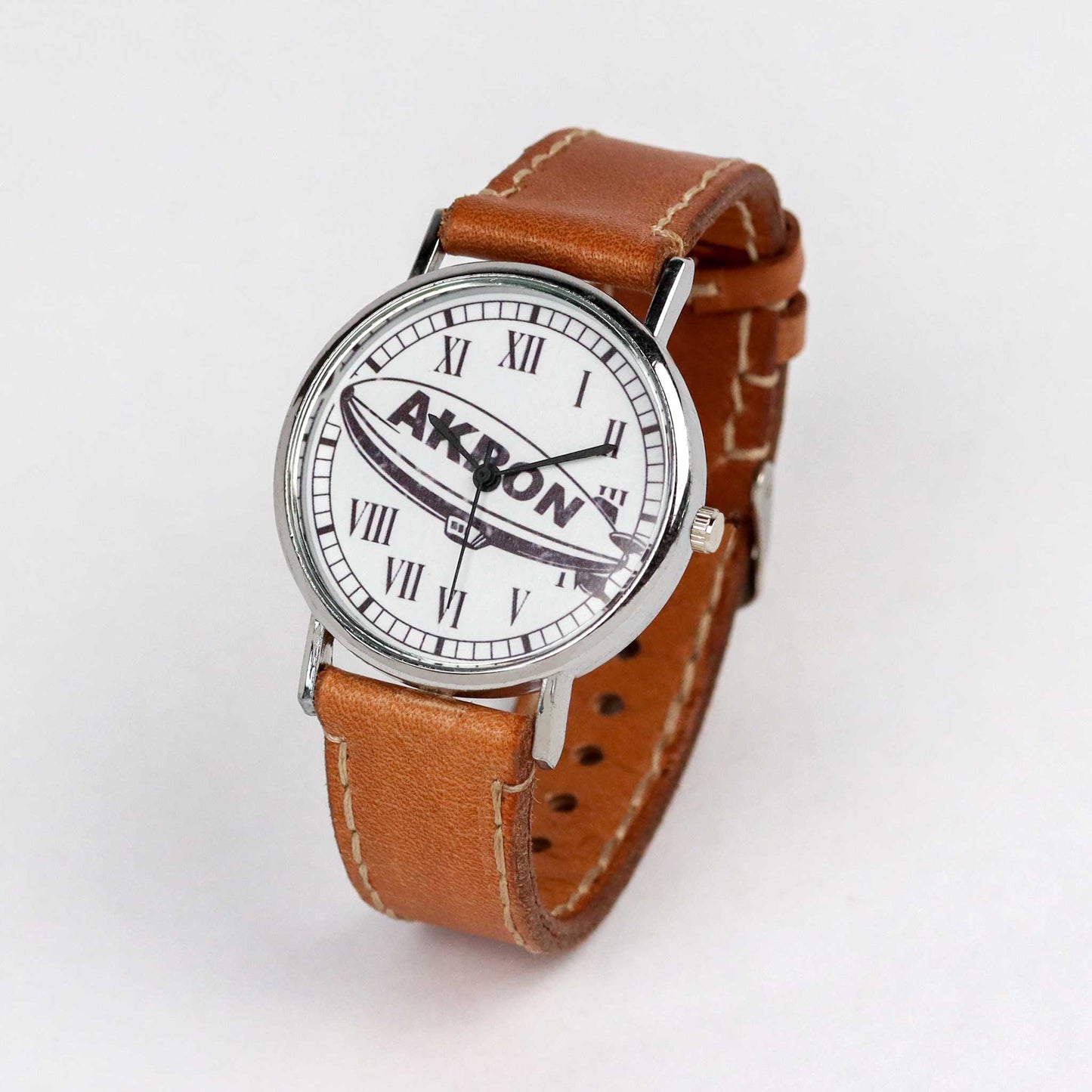 side view of an akron wrist watch with brown strap