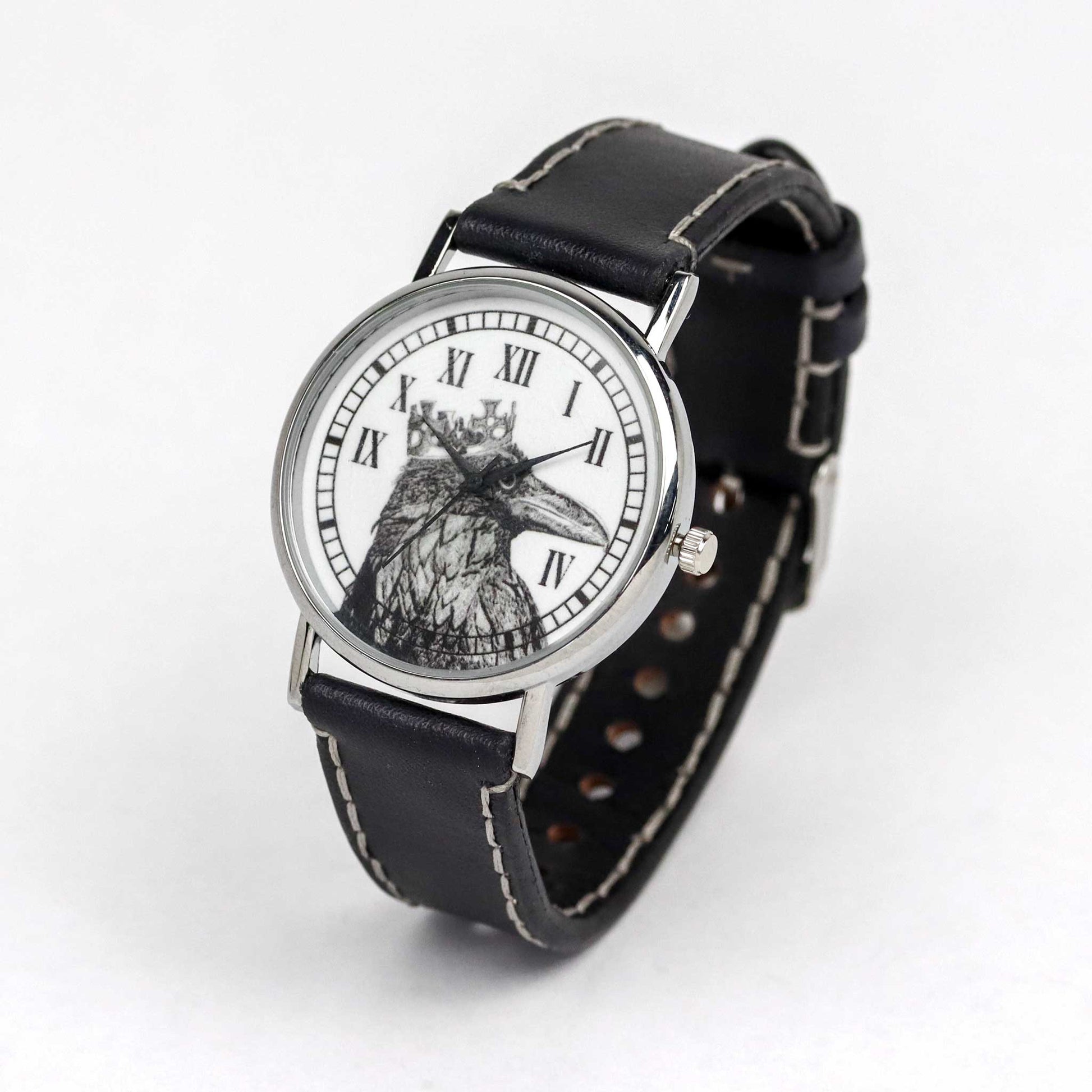 watch with a raven and crown on the dial and black strap